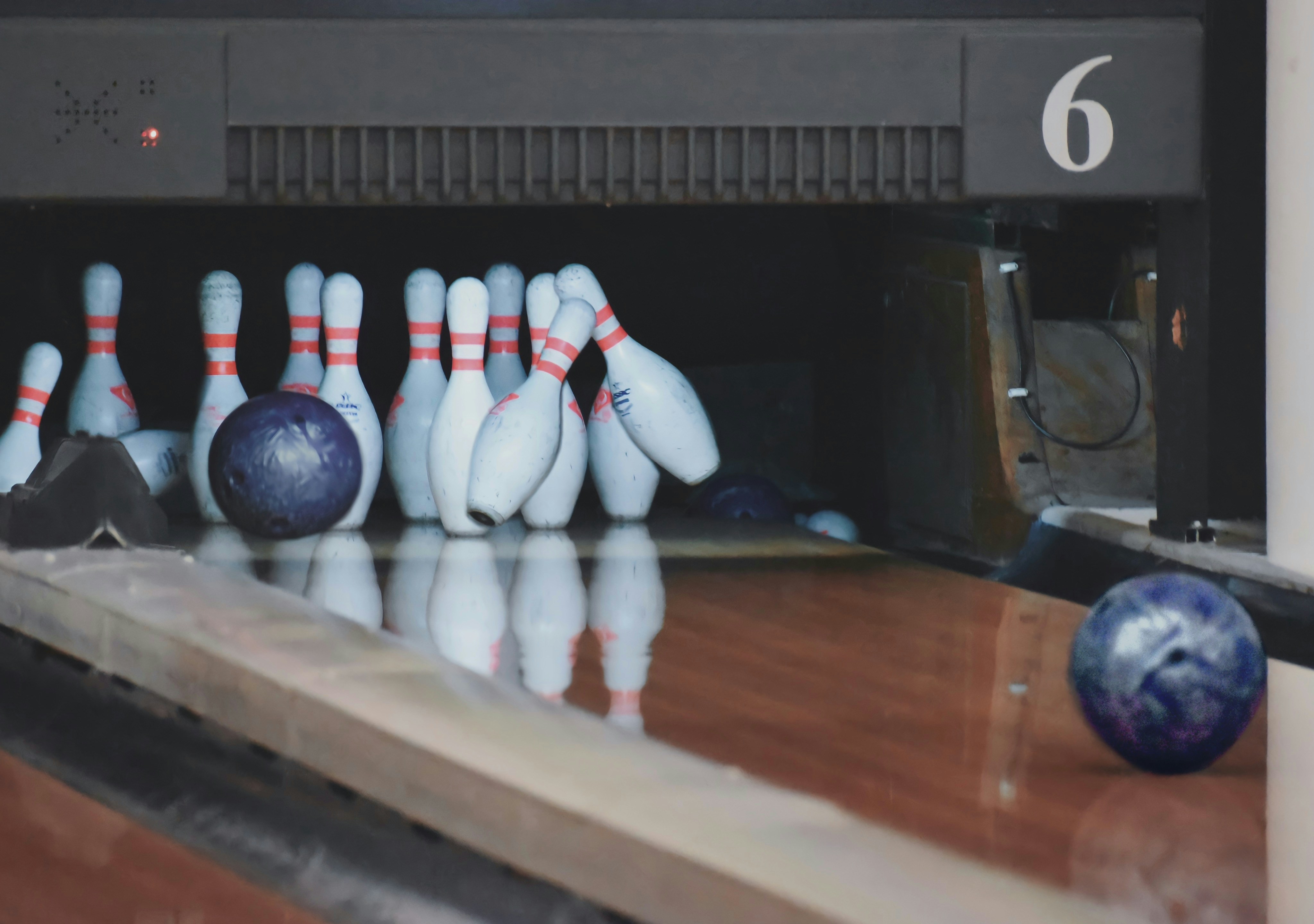 Bowling ball striking pins at lane 6