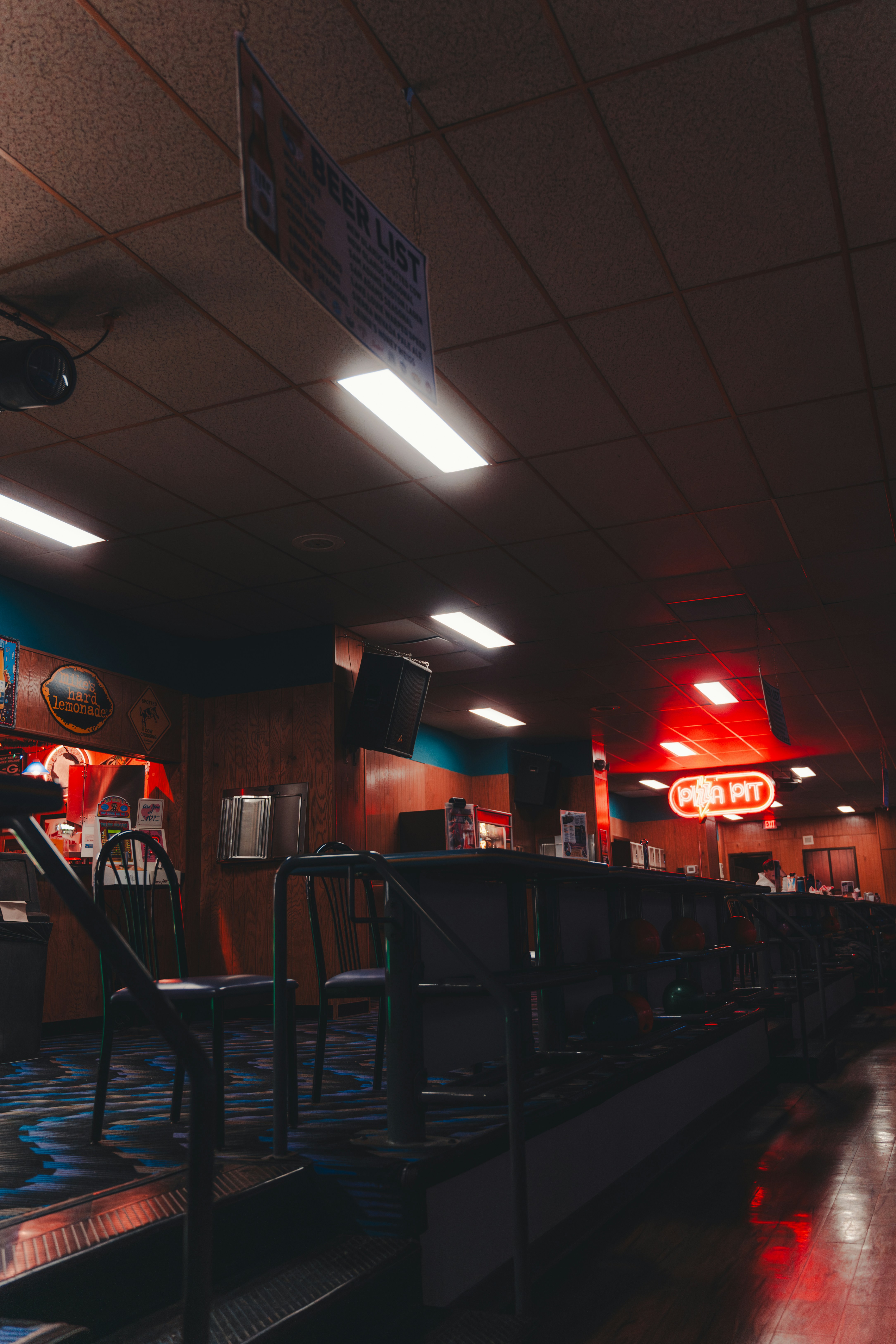 Dimly lit pub interior with neon sign