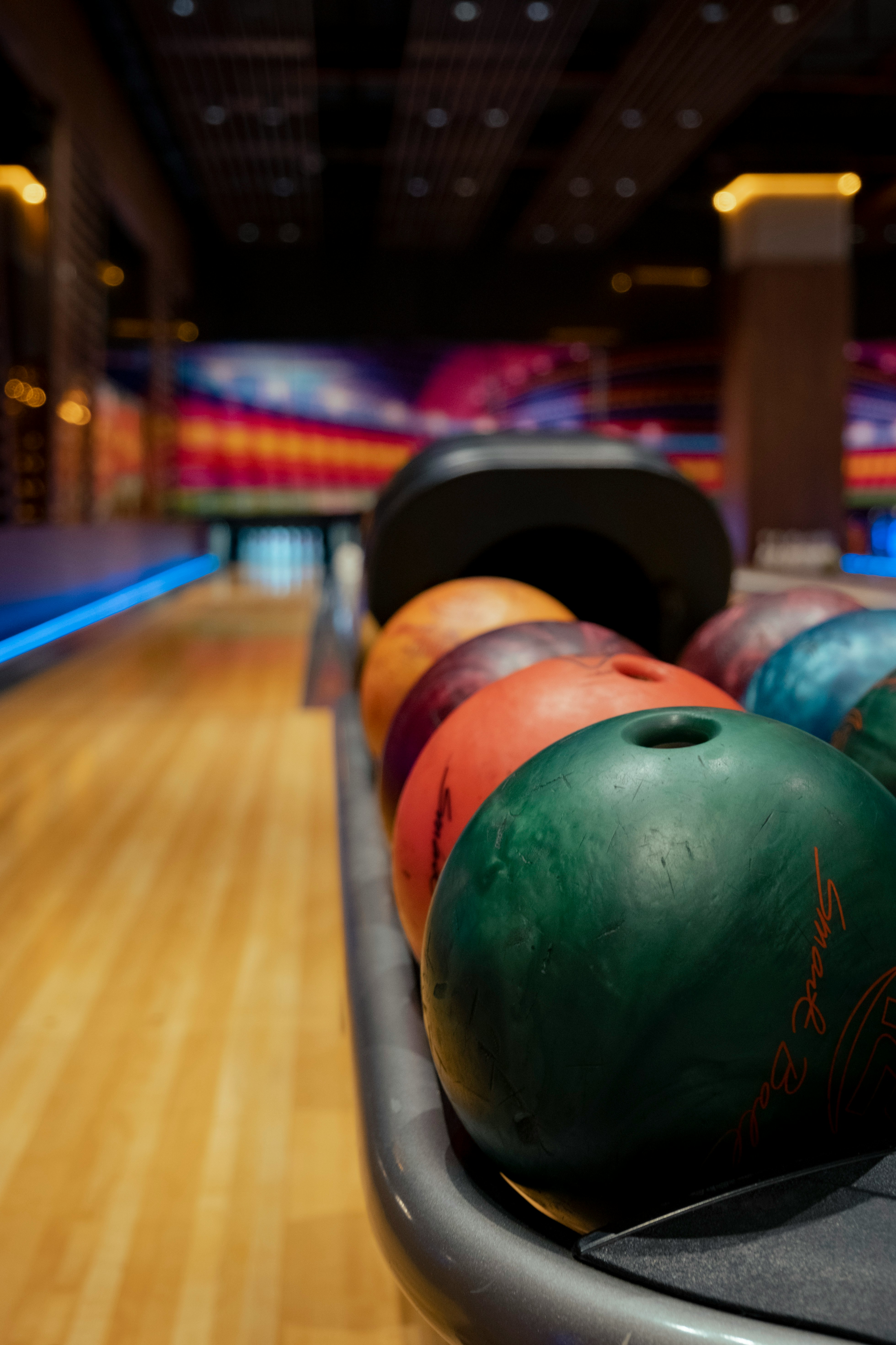 Modern bowling alley with colorful ball rack